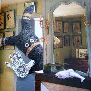 Collage image of a rabbit-like sock creature peeking around the corner into a living room and waving hello.